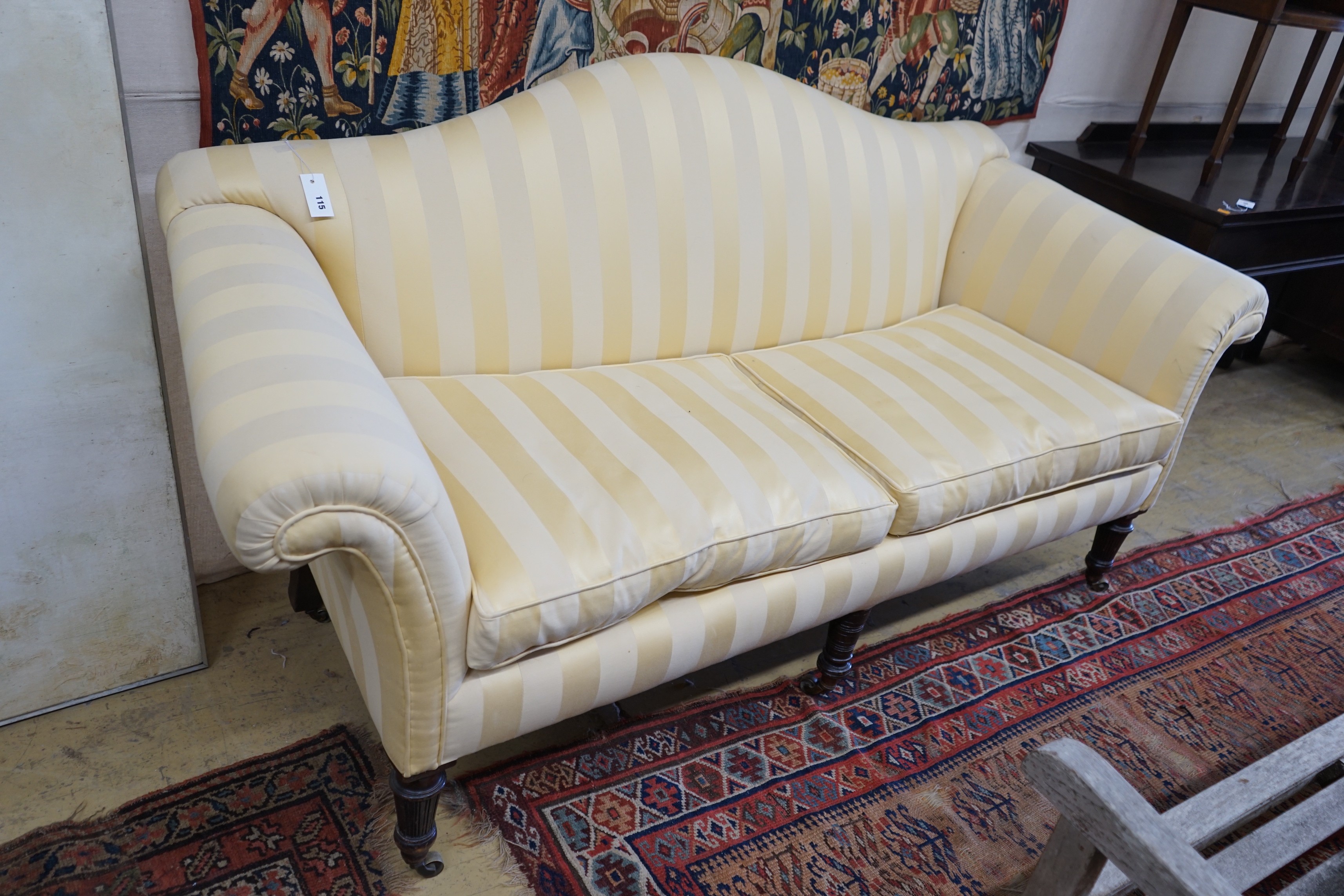 A Victorian scroll arm settee upholstered in ivory and gold striped fabric, length 186cm, depth 78cm, height 99cm